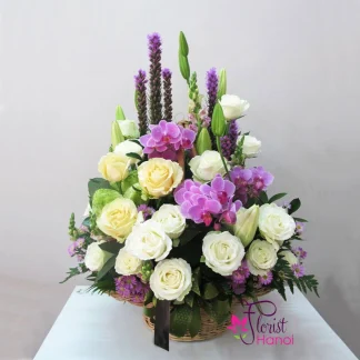 Basket of mixed flowers with white roses purple orchids and roses in Vietnam
