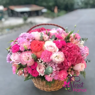 Beautiful flower basket for your wife with pink roses, hydrangeas, peonies, and seasonal flowers