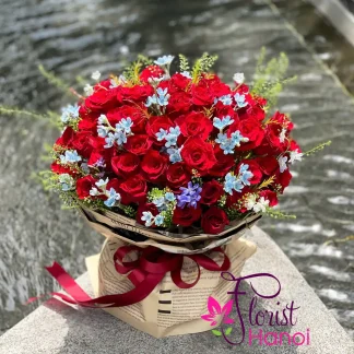 Beautiful red rose bouquet with delicate blue flowers handcrafted by Florist Hanoi in Vietnam