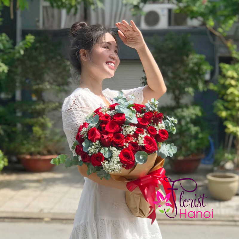 Woman happily holding a bouquet of fresh flowers