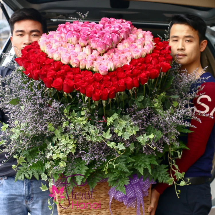 Florist arranging a heart shaped rose bouquet