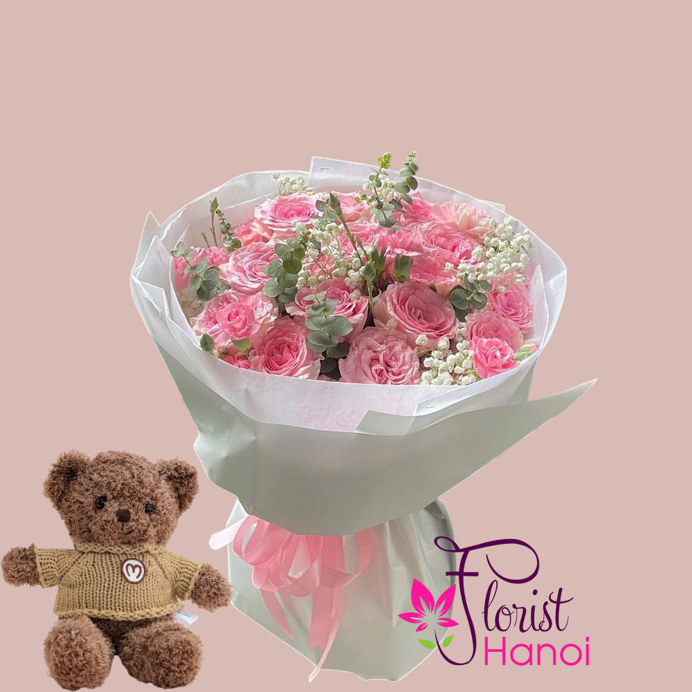 Bouquet of pink roses and teddy bear