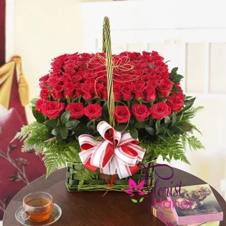 Red rose flower arrangement for love in an elegant woven basket