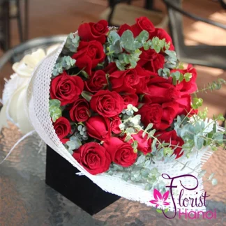 Romantic red roses bouquet in white mesh wrap
