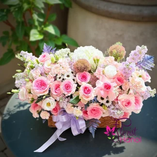 Sweet flower arrangement with pink roses, hydrangeas, lisianthus, and pastel seasonal flowers