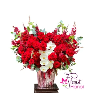 Luxury table flowers bouquet with red roses, white orchids and fresh greenery for birthday celebrations in Hanoi