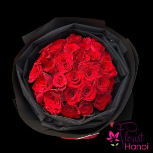 Red roses wrapped in black paper