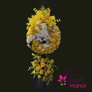 Yellow and white funeral flower arrangement